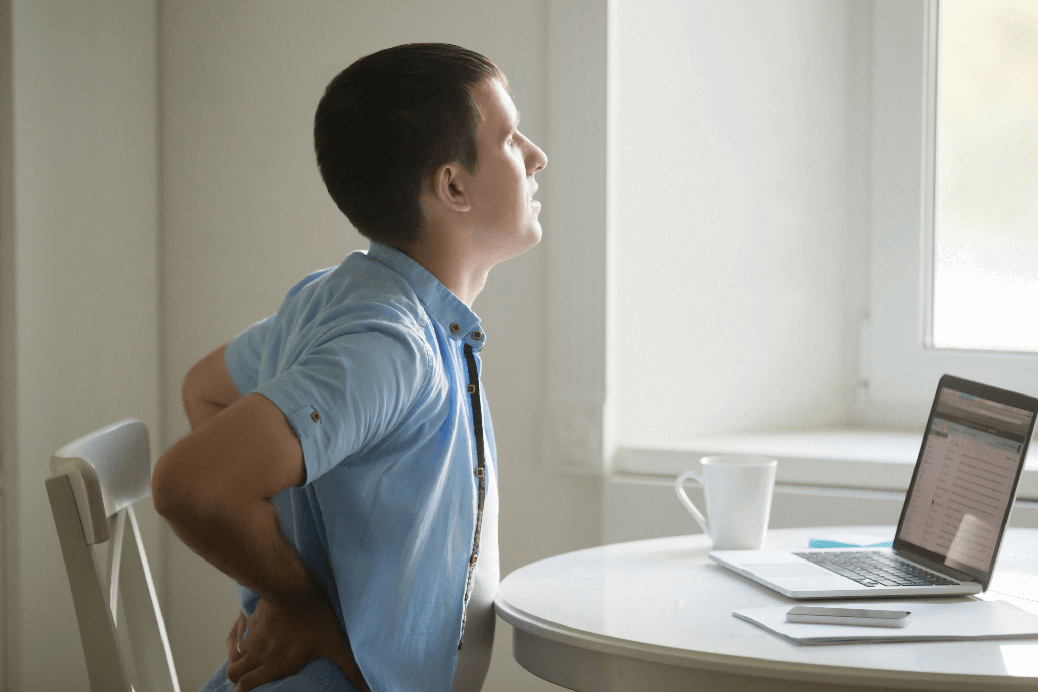 profile-portrait-man-laptop-stretching-backache-position (1)
